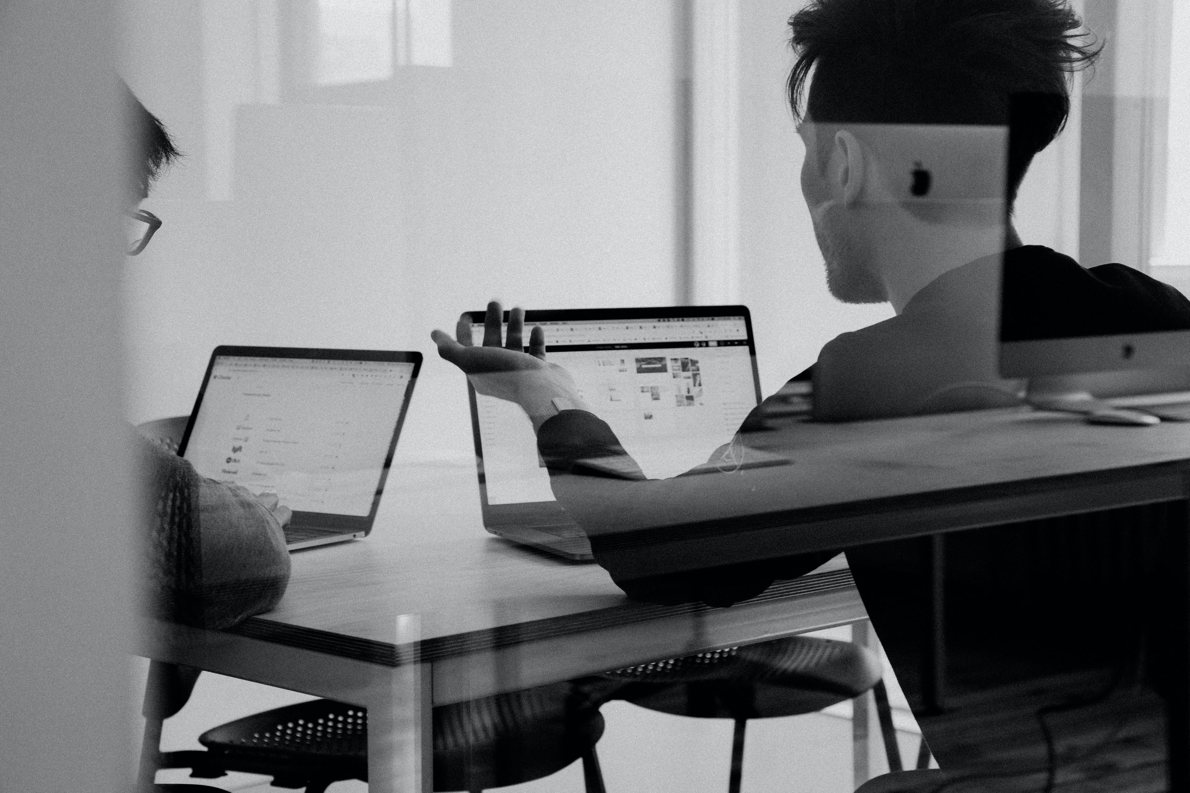 sample office image of two people looking at an iMac